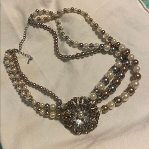 Elegant Multi-Strand Pearl Necklace with Silver Floral Pendant